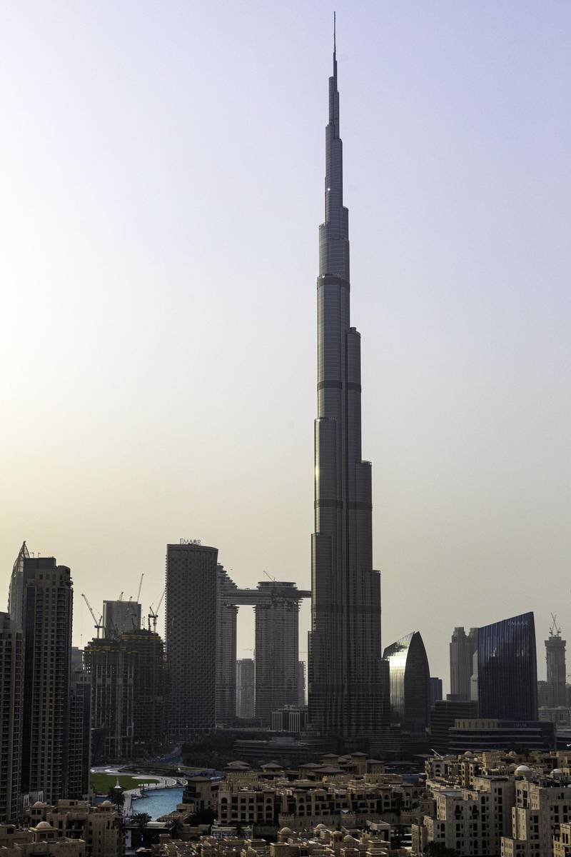 The Burj Khalifa skyscraper, center, towers above commercial and residential properties in Dubai, United Arab Emirates, on Tuesday, July 23, 2019. Like the rest of the city, the business center has suffered from a prolonged real-estate slump brought on by oversupply and slower economic growth. Photographer: Christopher Pike/Bloomberg