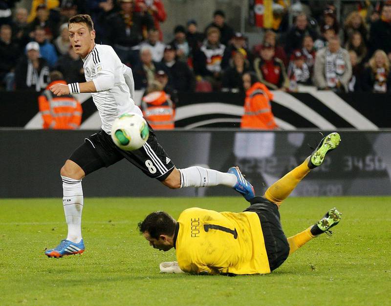 Arsenal's Mesut Ozil put the exclamation point on Germany's World Cup qualification on Friday with the team's third goal. Michael Probst / AP
