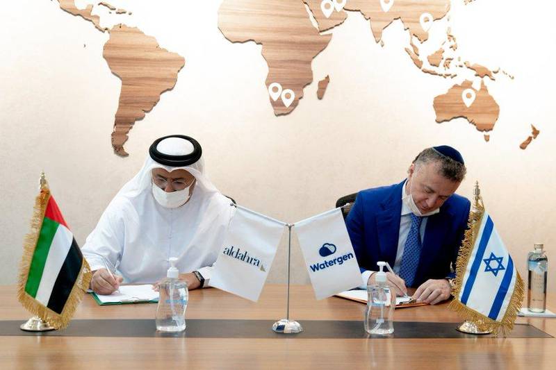 Khadim Al Darei, vice-chairman and co-founder of Al Dahra Holding and Michael Mirilashvili, CEO and president of Watergen, sign the agreement. Wam  