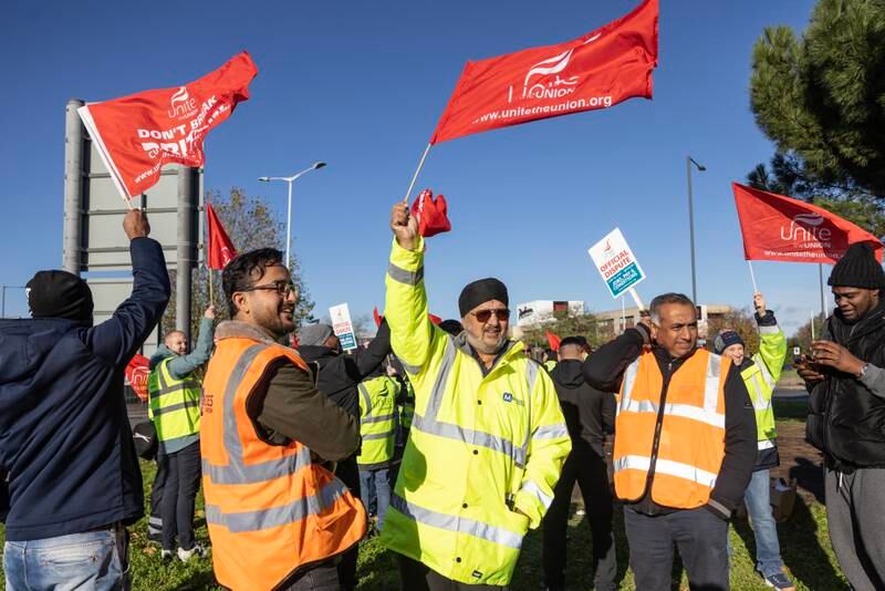 Ground staff gather at a picket line near Heathrow's Terminal 2 last month, with warning of more strikes in place. Getty Images