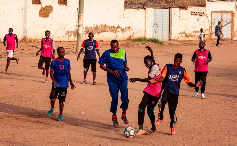 At sunset, friendly football matches are played on lots across Khartoum.