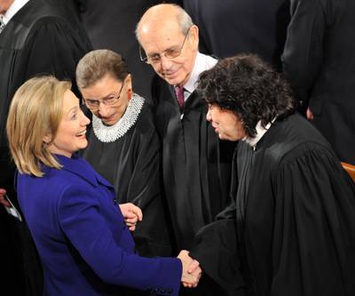 Secretary of State Hillary Clinton shakes hands with Supreme Court Justice Sonia Sotomayor along with Justices Ruth Bader Ginsburg and Stephen G Breyer before President Barack Obama's State of the Union Address. AFP