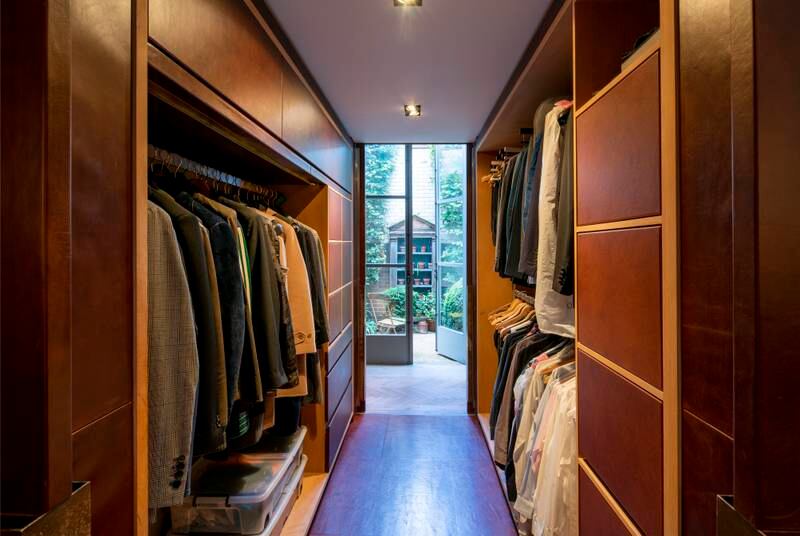 A walk-in closet with a view to the garden.