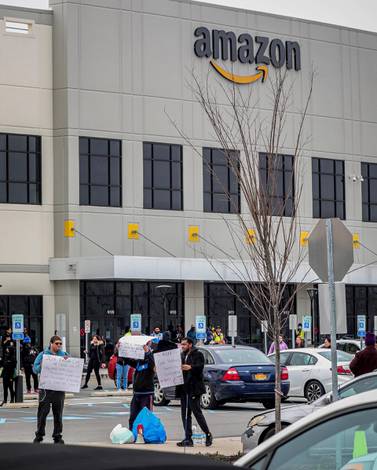 A temporary $2-an-hour hazard pay rise for its hundreds of thousands of warehouse workers would ultimately cost Amazon about $700m. AP Photo