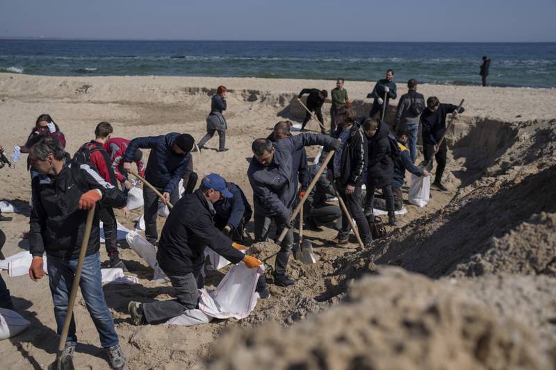 Volunteers at a beach fill sandbags to defend their city, Odesa, in southern Ukraine. AP