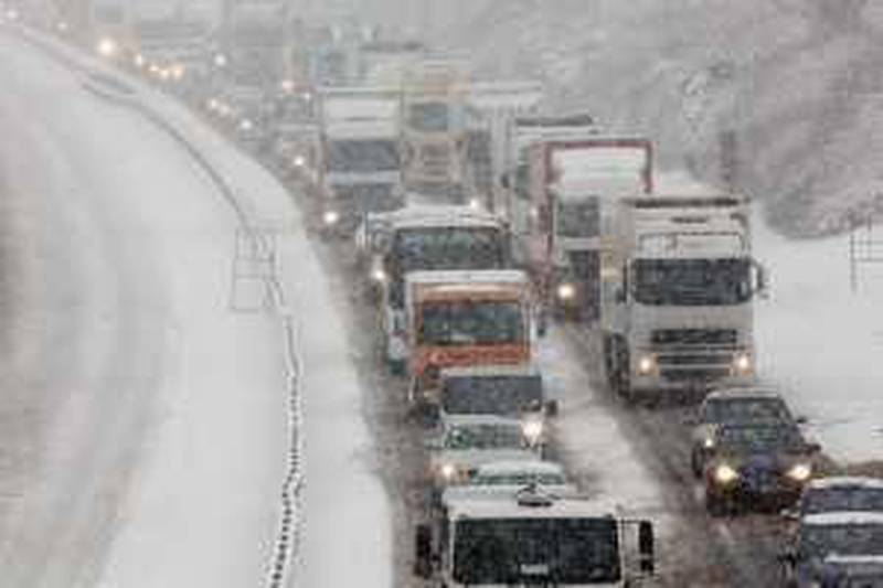 HARTHILL, SCOTLAND - DECEMBER 23:  Drivers struggle along the M8 near Harthill due to difficult driving conditions on December 23, 2009 in Harthill, Scotland. Fresh snow has fallen across the UK causing travel disruption and some road closures.  (Photo by Jeff J Mitchell/Getty Images) *** Local Caption ***  GYI0059190539.jpg