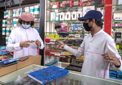 Abu Dhabi, United Arab Emirates, April 23, 2020.  A mobile phone customer at the  Mussafah 32 area during the Coronavirus pandemic.Victor Besa / The NationalSection:  NAFor: stock images and standalone