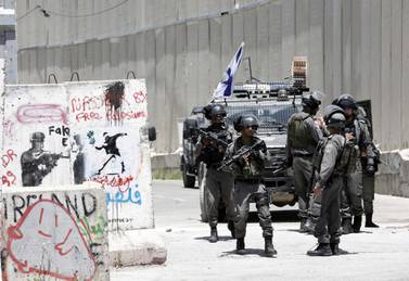 epa07572741 Israeli soldiers keep watch during a protest by Palestinians to mark the 71st anniversary of Nakba or catastrophe in the West Bank city of Bethlehem, 15 May 2019. Nakba Day, or Day of the Catastrophe, which is marked on 15 May to commemorate the expulsion of more than 700,000 Palestinians from their land in the war surrounding the establishment of the state of Israel. EPA/ABED AL HASHLAMOUN