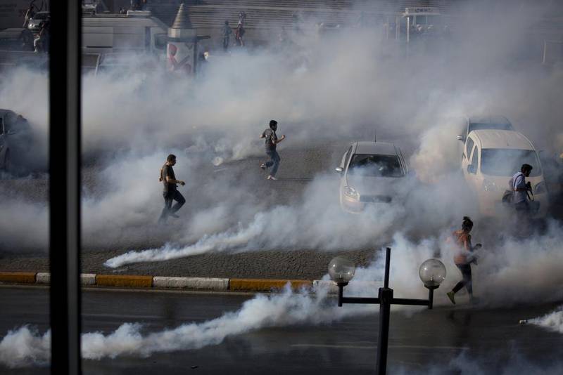 Protesters against the demolition of Gezi Park in Istanbul flee tear gas, May 2013. Ed Ou / Getty Images.