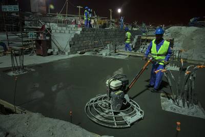 Workers treat concrete as they work during their night shift at the Louvre Abu Dhabi construction site on Saadiyat Island in Abu Dhabi. The construction of the future gallery is continuous, and stretches through whole nights to accommodate specific work-needs. Silvia Razgova / The National