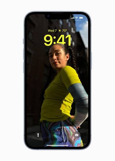 The reimagined Lock Screen in iOS 16 offers a multilayered effect that sets subjects of photos in front of the time, along with newly designed widgets. Photo: Apple