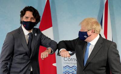 Prime Minister Boris Johnson and Canada's Prime Minister Justin Trudeau elbow bump before a bilateral meeting in Carbis Bay. Reuters