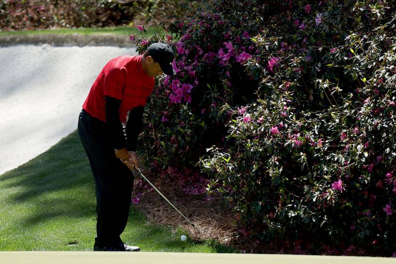 Tiger Woods plays his shot left-handed on the 13th hole during the final round of the Masters. Getty
