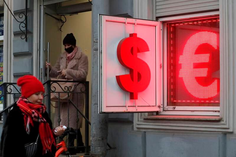 A Russian woman leaves an exchange office displaying US dollar and euro currency signs in St Petersburg, Measured over a decade, the US dollar is up 16.8 per cent against the euro, 23.53 per cent against the pound, and 63.2 per cent against the Japanese yen. EPA