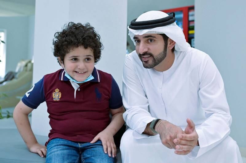 Sheikh Hamdan meets a boy at Dubai Autism Centre.