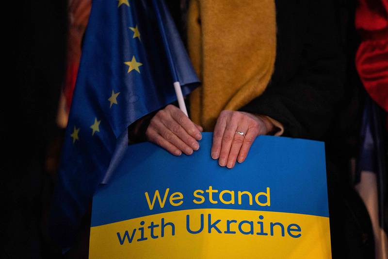 A supporter holds a sign to support Ukraine during Paris' mayor and 'Socialist party' (PS) presidential candidate's campaign meeting in Rennes, western France. AFP