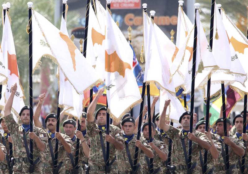 Soldiers march in a military parade marking the 61st anniversary of Cyprus' independence from British colonial rule in Nicosia last October. Cyprus was split along ethnic lines following Turkey's invasion in 1974. AP Photo