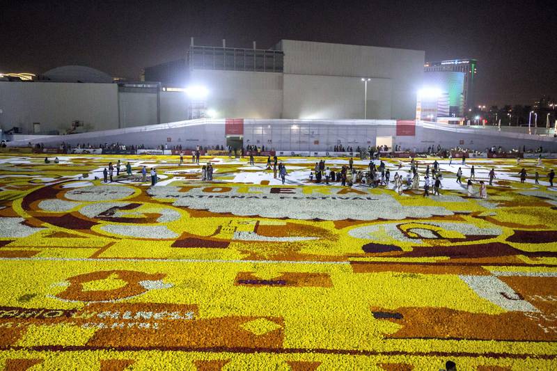 Dubai, United Arab Emirates- Thousands of volunteers laying out fresh flowers at the worlds largest fresh flower carpet with the theme of Tolerance to highlight UAE as a global capital  for tolerance at Dubai Festival City.  Leslie Pableo for The National (Please note that they did not break the world record as they ran out of fresh flowers)
