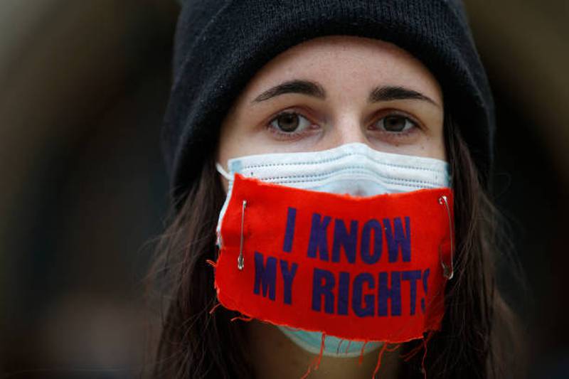 A protester from Extinction Rebellion wears a facemask saying 'I know my rights' outside Guildhall. Getty Images
