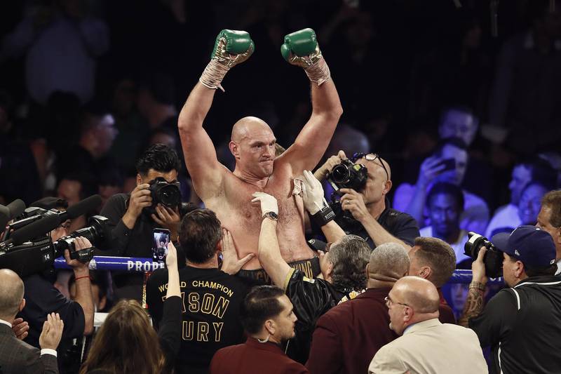 Tyson Fury celebrates defeating Deontay Wilder to win the WBC World Heavyweight Championship at the Garden Arena in Las Vegas.