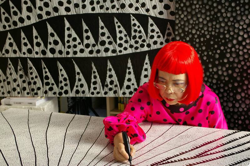 Japanese artist Yayoi Kusama works on one of her creations. Tokyo Lee Productions, Inc.