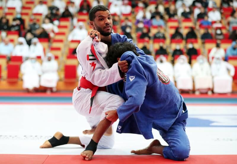 Khalid Al Ali of Al Jazira, right, fights Theyab Al Nuaimi of Al Ain in the bronze medal match in the President's Cup.
