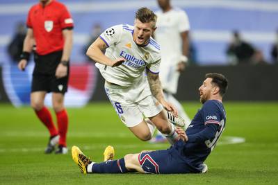 Messi tackles Real Madrid's Toni Kroos. AP
