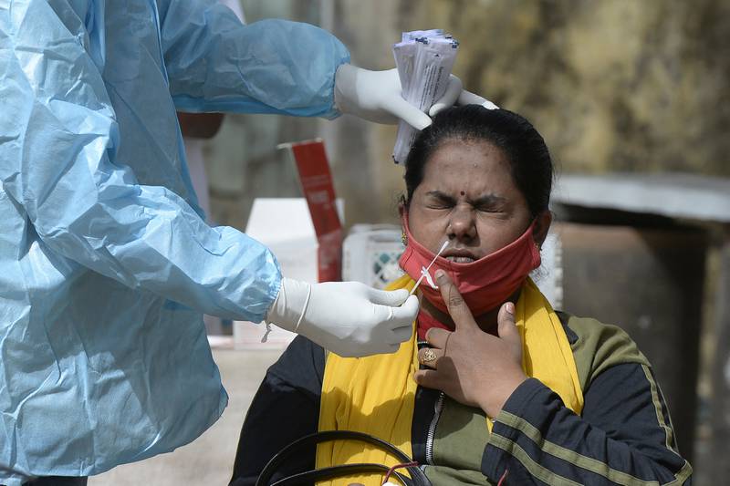 A health worker collects a swab sample at a government hospital in Hyderabad. AFP