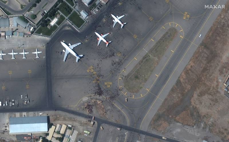 A satellite photo shows swarms of people on the tarmac at Kabul International Airport, also known as Hamid Karzai International Airport. Afghans rushed on to the tarmac of the capital's airport on Monday as thousands tried to flee the country after the Taliban seized power with stunning speed.
