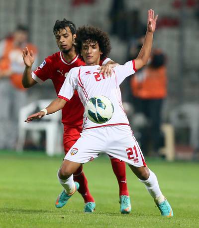 Omar Abdelrahman (front) of the United Arab Emirates vies for the ball against Rashed al-Hooti of Bahrain during the two teams in the 21st Gulf Cup in Manama, on January 8, 2013. The Emiartes won 2-1. AFP PHOTO/MARWAN NAAMANI
 *** Local Caption ***  216379-01-08.jpg