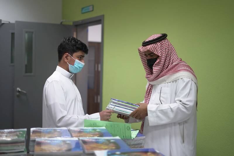 A Saudi pupil collects his books at a school in Riyadh, Saudi Arabia. The kingdom has reintroduced the mandatory wearing of face masks. Reuters