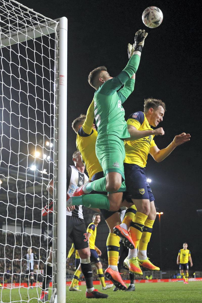 Newcastle United's English goalkeeper Karl Darlow jumps to claim the ball during the FA Cup fourth round replay football match between Oxford United and Newcastle United at the Kassam Stadium in Oxford, west of London, on February 4, 2020. - Newcastle won the game 3-2 after extra time. (Photo by Adrian DENNIS / AFP) / RESTRICTED TO EDITORIAL USE. No use with unauthorized audio, video, data, fixture lists, club/league logos or 'live' services. Online in-match use limited to 120 images. An additional 40 images may be used in extra time. No video emulation. Social media in-match use limited to 120 images. An additional 40 images may be used in extra time. No use in betting publications, games or single club/league/player publications. / 