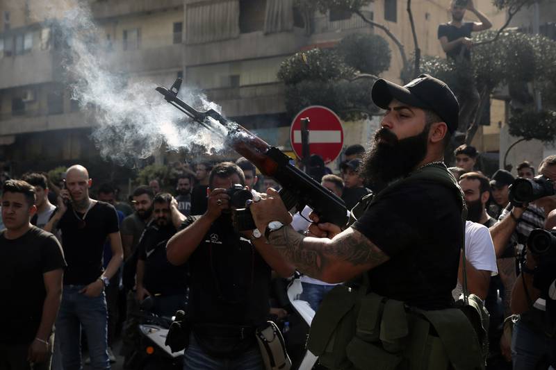 A supporter of the Shiite Amal group fires into the air during funeral processions in the southern Beirut suburb of Dahiyeh. AP