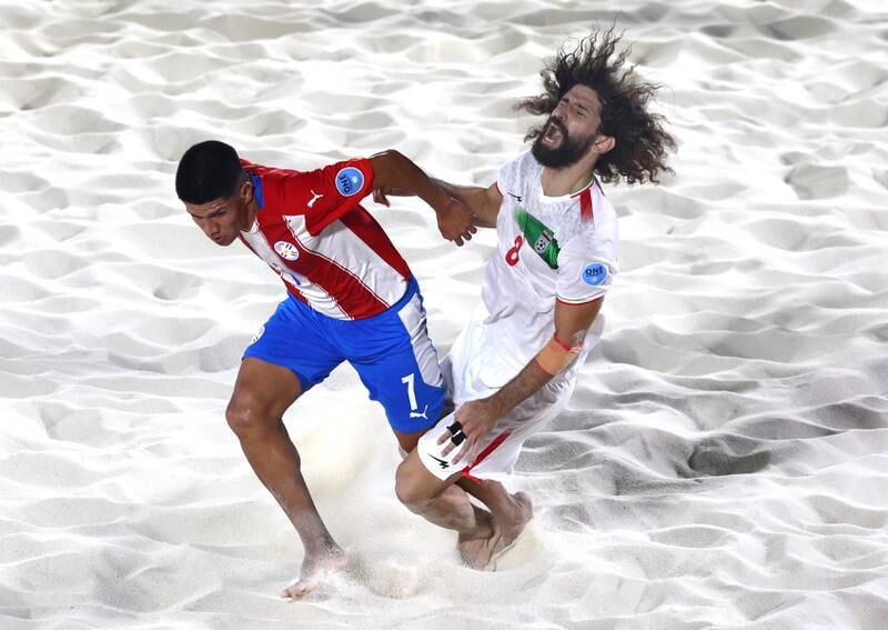 Movahed Baltork of Iran collides with Milciades Chavez of Paraguay during a group match. Getty