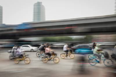 People riding bicycles in Chaoyang district, Beijing. China's capital city announced three rounds of mass testing after a Covid-19 outbreak at a bar after the city eased restrictions.   EPA