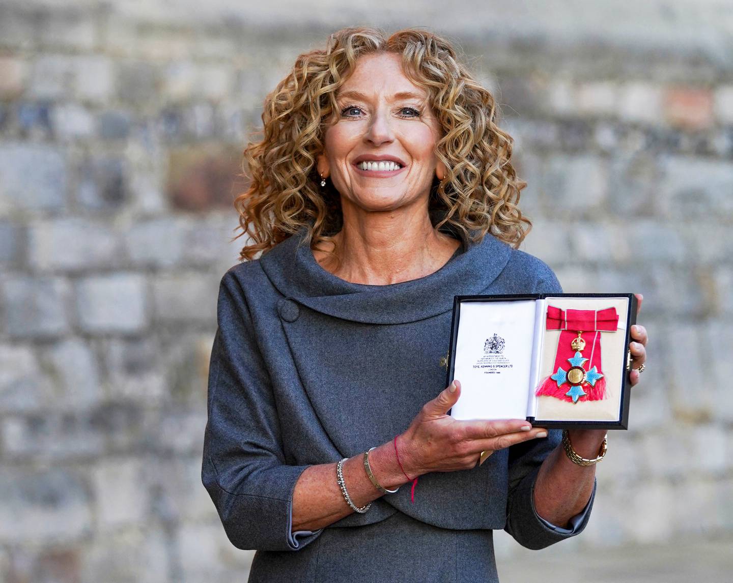 Kelly Hoppen poses after the ceremony at Windsor Castle in London, where she was awarded Commander of the Order of the British Empire (CBE) in November 2021.AFP