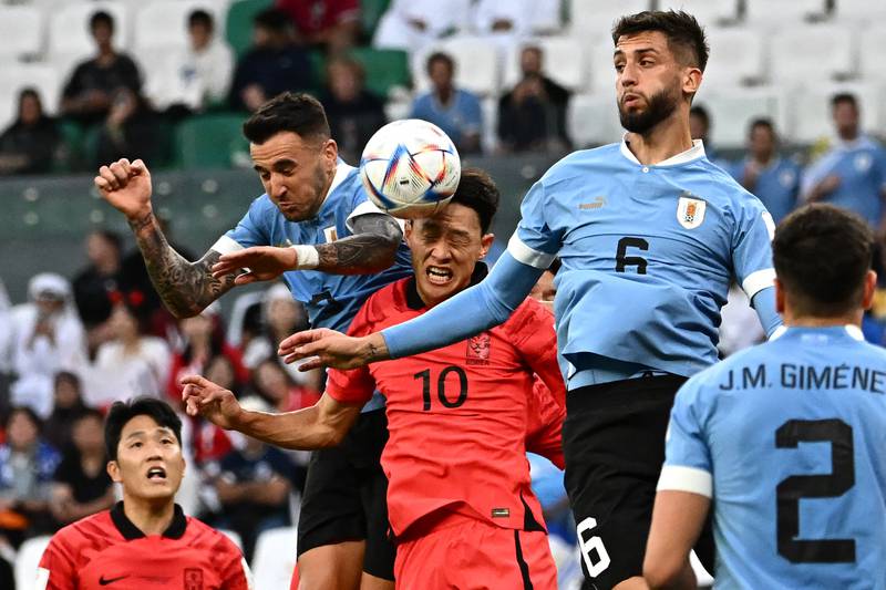 Lee Jae-sung faces off against Uruguay's Rodrigo Bentancur. AFP