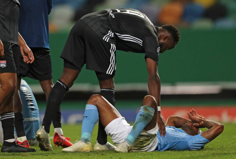 Lyon's Moussa Dembele consoles Manchester City's Raheem Sterling at the end of the match. AP