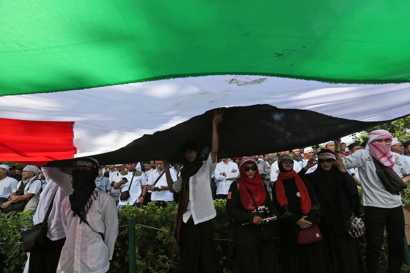Protesters display a large Palestinian flag during a rally outside the US Embassy in Jakarta on December 8, 2017. Tatan Syuflana / AP Photo