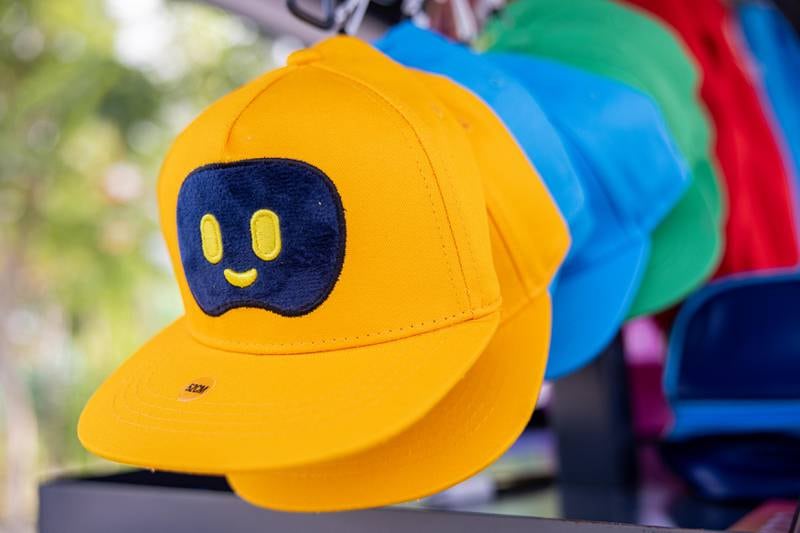 A hat featuring the robot Opti comes in multiple colours.
