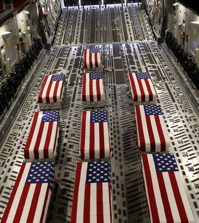 Flag-draped coffins of service members killed in action are loaded on to a transport aircraft during a ramp ceremony at Hamid Karzai International Airport in Kabul on August 27, 2021. Reuters