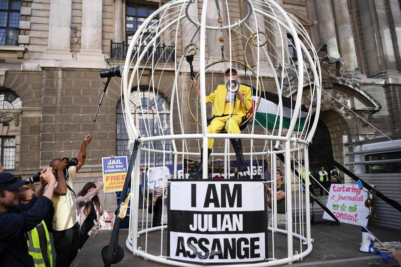 Ms Westwood sat in a bird cage pretending to be a canary to highlight perceived injustices over the extradition. EPA