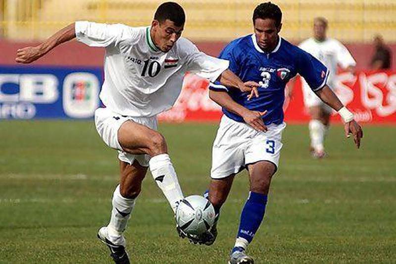 Iraq's Yunis Khalaf, left, fights for the ball against Kuwait's Saqer Al Antari during a friendly match in Amman. The two rivals renew their battles on the pitch in the Gulf Cup of Nations starting Saturday.