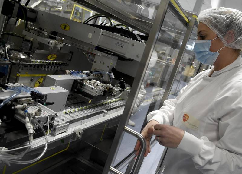 An employee works on a production line at the factory of British multinational pharmaceutical company GlaxoSmithKline (GSK) in Saint-Amand-les-Eaux, northern France, on December 3, 2020, where the adjuvant for Covid-19 vaccines will be manufactured.  Canada's Medicago and British pharmaceutical giant GlaxoSmithKline (GSK) announced on December 3, 2020 the launch of phase 2 and 3 clinical trials on a Covid-19 vaccine, one of a series of candidates being developed worldwide. Final phase 3 trials of the plant-derived vaccine candidate will begin by year's end and will be tested on 30,000 volunteers in North America, Latin America and Europe, according to a joint statement.

 / AFP / FRANCOIS LO PRESTI
