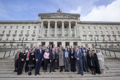 Attendees of the 63rd Plenary of the British-Irish Parliamentary Assembly pose together in March on the steps of Parliament Buildings in Stormont in Belfast, to mark the 25th anniversary of the agreement. PA