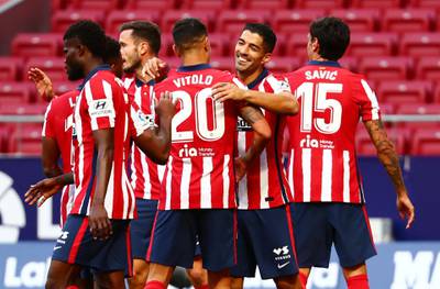 Luis Suarez celebrates with teammates after scoring Atletico's sixth goal. Reuters