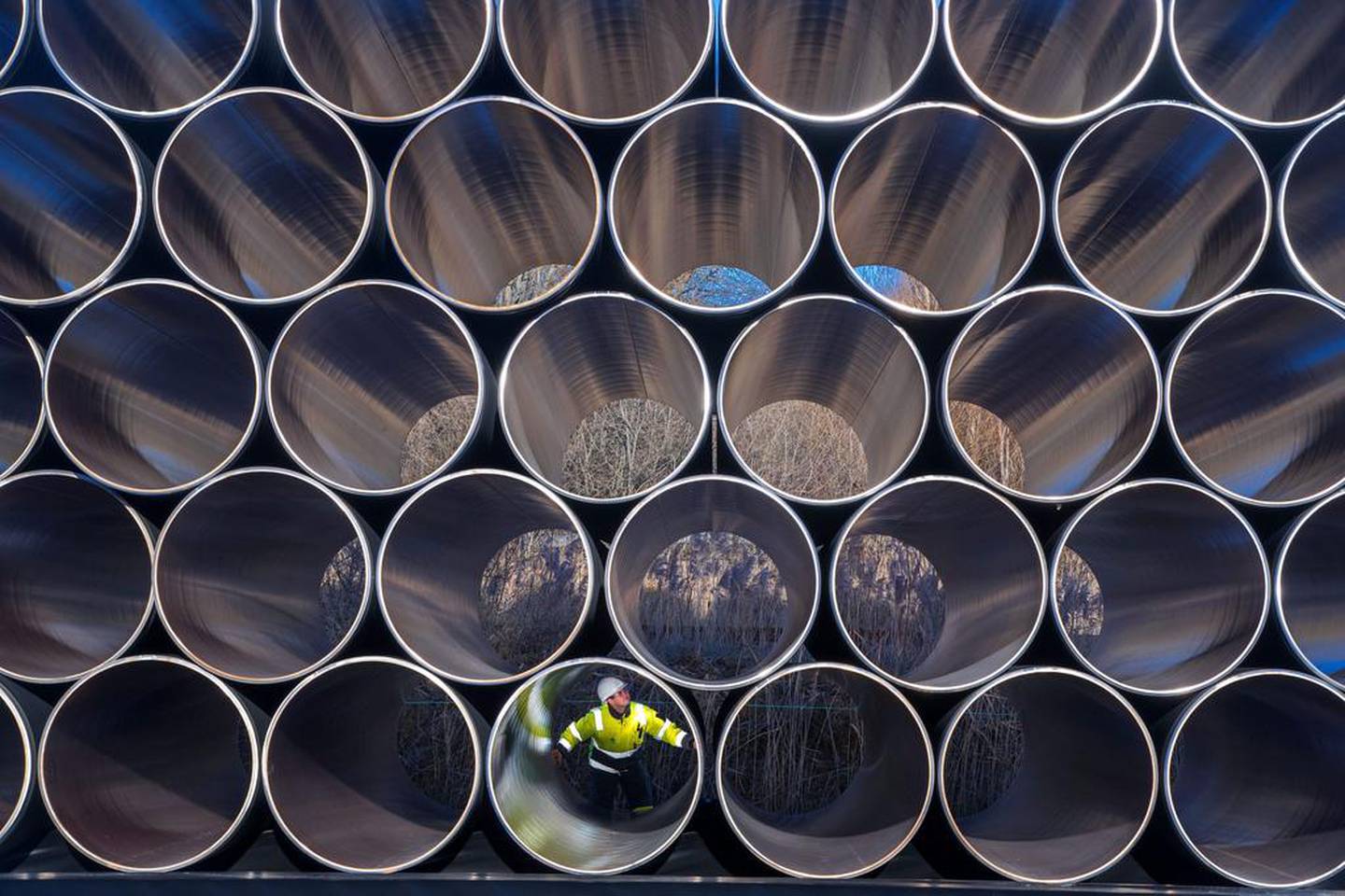 A worker inspects stacks of pipes weighing several tonnes each that will be used for the construction of the Nord Stream gas pipeline in the Sassnitz-Mukran harbour in Germany. EPA