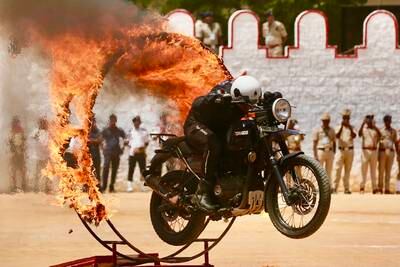 Members of the Indian Army Service Corps team display their motorbike skills during Independence Day celebrations in Bangalore. EPA