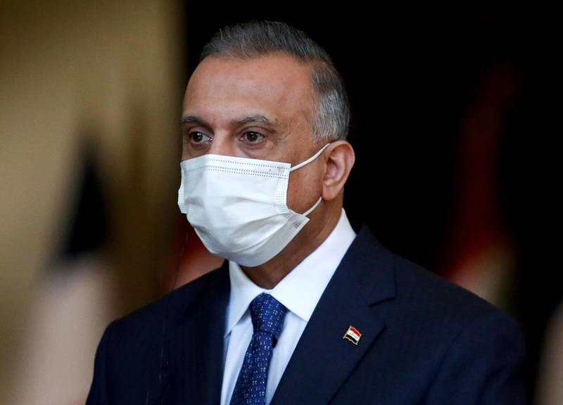 Iraq's Prime Minister Mustafa al-Kadhemi, mask-clad due to the COVID-19 coronavirus pandemic, looks on during a joint press conference with the French president in Baghdad on September 2, 2020. French President Emmanuel Macron landed in Baghdad on his first official trip to Iraq, where he hopes to help the country reassert its "sovereignty" after years of conflict. / AFP / POOL / GONZALO FUENTES
