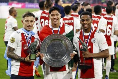 From left, Lisandro Martinez, Edson Alvarez, and Jurrien Timber of Ajax with the Dutch league trophy. EPA